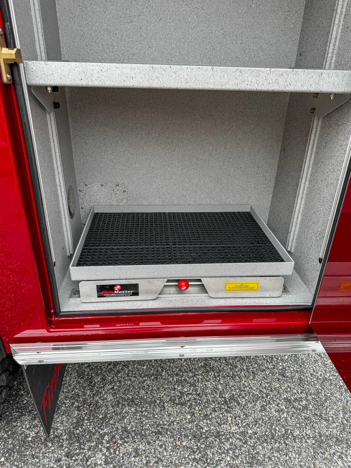 Side compartment tray extended view showing tray edge and shelf framing.